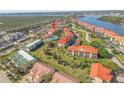 Aerial view of community condos with a pool, mature trees, lush landscaping, and well-maintained lawns at 445 Bouchelle Dr # 104, New Smyrna Beach, FL 32169