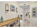 Inviting entryway with bench, light wood floors, and view to living area at 445 Bouchelle Dr # 104, New Smyrna Beach, FL 32169