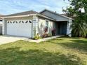 Charming single-story home with a well-manicured lawn and attached two-car garage at 4618 Prairie Point, Kissimmee, FL 34746