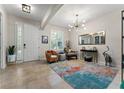 A cozy living room with tile floors, a vibrant rug, a modern chandelier, and stylish decor at 4862 Grand Vista Ln, St Cloud, FL 34771