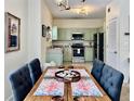 Dining area featuring a stylish table with seating for six, and modern light fixture at 489 Water St # 489, Celebration, FL 34747