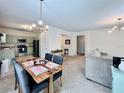 Open-concept living room and dining area with views into the kitchen at 489 Water St # 489, Celebration, FL 34747