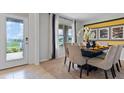 Dining room with stylish table setting, plush chairs, modern decor, and view to the backyard at 5215 Ligonberry St, Lakeland, FL 33811