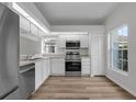 Bright kitchen with stainless steel appliances, white cabinets, and a view from the window at 5669 Parkview Lake Dr, Orlando, FL 32821