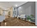 Entryway with decorative bench, light gray accent wall, and wood floors at 638 Maple Oak Cir # 112, Altamonte Springs, FL 32701