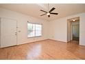 Spacious living room features beautiful hardwood floors, neutral walls, and a ceiling fan at 691 Monroe Harbor Pl, Sanford, FL 32773