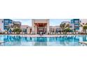 Stunning pool with plenty of lounge chairs, umbrellas and palm trees at a luxurious apartment complex at 7810 Spectrum Dr, Kissimmee, FL 34747