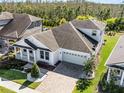 Beautiful home with manicured lawn, paver driveway and walkway, plus a spacious two car garage at 8356 Corkfield Ave, Orlando, FL 32832