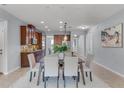 Open dining room features a large table and modern neutral decor, seamlessly connecting to the kitchen at 8356 Corkfield Ave, Orlando, FL 32832