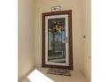 Close-up of the front door featuring a decorative wreath and a welcome mat at 8878 Conway Rd, Polk City, FL 33868