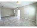 Bright, open living space features tiled floors and two windows letting in ample natural light at 10079 Memoir Ave, Winter Garden, FL 34787