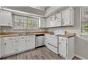 Bright kitchen showcasing white appliances, laminate countertops, and ample storage space at 119 Winterglen Dr Dr, Sanford, FL 32771