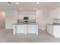 Modern kitchen with white cabinetry, granite countertops, and stainless steel appliances at 1409 Dalkeith Cv, Sanford, FL 32771