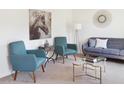 Cozy living room featuring modern decor, a comfortable sofa, and stylish chairs at 1415 Dalkeith Cv, Sanford, FL 32771