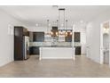 Spacious kitchen with stainless steel appliances, dark cabinets, granite counters, and stylish pendant lights at 14165 Moniz Ave, Orlando, FL 32827