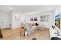 Spacious living room features light hardwood floors, modern furniture, and white paint at 1517 E Esther St, Orlando, FL 32806