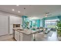Open concept kitchen with stainless steel appliances, granite countertops, and bar seating at 159 Captiva Dr, Davenport, FL 33896