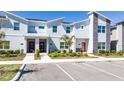 Modern townhomes with colorful doors, stone accents and lush landscaping, conveniently located near parking spaces at 2636 Reading Trl, Kissimmee, FL 34746