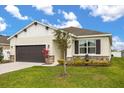 Beautiful single-story home with lush landscaping, a two-car garage, and stone accents at 2706 Rowan St, Tavares, FL 32778