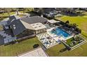 Aerial view of property featuring a modern pool, outdoor kitchen, and sand volleyball court at 2844 Marquesas Ct, Windermere, FL 34786