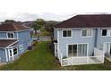 View of a backyard with a white fence and sliding doors leading to the townhouse at 373 Caribbean Dr, Davenport, FL 33897