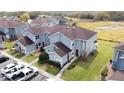 Aerial view of a complex of two-story townhouses with well-manicured lawns and parking at 373 Caribbean Dr, Davenport, FL 33897