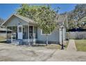 Exterior of a charming home featuring a screened in porch and mature landscaping at 3807 S Sanford Ave, Sanford, FL 32773