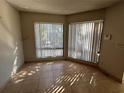 Living room filled with sunlight from large windows at 4358 Aqua Vista Dr # G, Orlando, FL 32839
