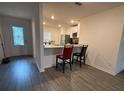 Open concept kitchen featuring granite countertops, stainless steel appliances, and eat-in breakfast bar at 439 Mulberry Ct, Kissimmee, FL 34759