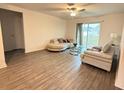Bright living room with hardwood floors, modern furnishings, and a sliding glass door at 439 Mulberry Ct, Kissimmee, FL 34759