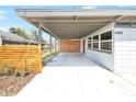 Spacious carport offering ample covered parking with a modern fence and neutral color palette, enhancing the home's exterior at 4429 Rossmore Dr, Orlando, FL 32810