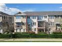 Charming multi-story townhome with manicured landscaping and classic architectural details at 450 Windmill Palm Cir, Altamonte Springs, FL 32701