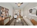 Stylish living room featuring dark wood floors, comfortable seating, contemporary artwork, and an open layout at 450 Windmill Palm Cir, Altamonte Springs, FL 32701