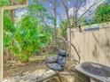 Cozy backyard with a swinging chair, lush palms, and a welcoming atmosphere for relaxation and outdoor enjoyment at 4952 Matteo Trl, Orlando, FL 32839