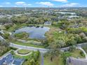 Stunning aerial view of a home nestled near a serene lake surrounded by lush greenery at 500 Forest Lake Dr, Altamonte Springs, FL 32714