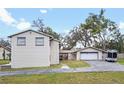 View of back of house with a detached garage and wide driveway, perfect for extra parking at 500 Forest Lake Dr, Altamonte Springs, FL 32714