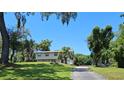Two-story home with a large yard and mature trees providing ample shade on a sunny day at 500 Forest Lake Dr, Altamonte Springs, FL 32714