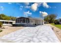 Single-story home featuring a large driveway with custom geometric detail at 519 Tivoli Park Dr, Davenport, FL 33897