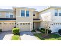 Attractive two-story townhome featuring a one car garage and well-maintained landscaping at 5412 Caramella Dr, Orlando, FL 32829