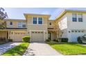 Inviting townhome with a well-manicured lawn and a single-car garage with a neutral colored door at 5412 Caramella Dr, Orlando, FL 32829