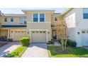 Inviting townhome with a well-manicured lawn and a single-car garage with a neutral colored door at 5412 Caramella Dr, Orlando, FL 32829