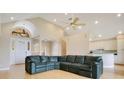 Open-concept living room featuring a high ceiling, ceiling fan, and views of the kitchen at 5850 Sheryl Anita St, Oviedo, FL 32765