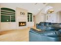 Cozy living room featuring a fireplace, built-in shelves, and comfortable seating at 5850 Sheryl Anita St, Oviedo, FL 32765