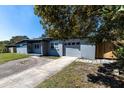A single-story home featuring a gray exterior, a well-maintained lawn, and an attached garage at 714 Kankakee Ln, Orlando, FL 32807