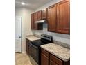 Close up of the kitchen with stainless steel oven, light countertops and wooden cabinets at 717 Squires Grove Dr, Winter Haven, FL 33880