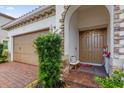 Inviting front entrance featuring a double door entry, decorative stone accents, and a brick-paved landing at 10257 Henbury St, Orlando, FL 32832