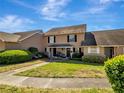 Exterior view of townhouses, showcasing manicured lawns and inviting front entrances at 1174 Villa Ln # 115, Apopka, FL 32712