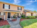 Lovely townhouse with well-kept lawn, complemented by dark shutters and a welcoming front entrance at 1174 Villa Ln # 115, Apopka, FL 32712