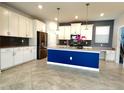Bright kitchen showcasing white cabinetry, a stylish island, and stainless steel appliances at 11810 Imaginary Way, Orlando, FL 32832
