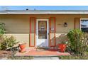 Close-up of the front door with orange trim and a charming welcome sign at 14884 at 14884 Sw 35Th Cir, Ocala, FL 34473